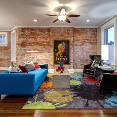 Eclectic Living Room Features Brick Accent Wall & Colorful Furnishings