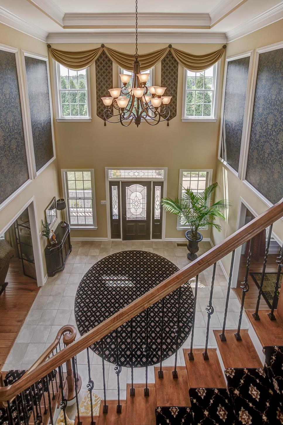 Grand Foyer Boasts Lofty Ceiling and Elegant Chandelier | HGTV