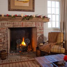 Country Living Room With Brick Fireplace and Plaid Chair