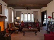 White Country Living Room With Wood Ceiling and Brown Sofa