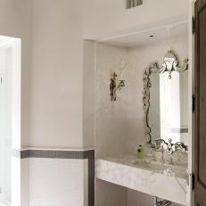 Chic White Bathroom Features Sleek Marble Countertop