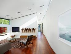 Modern White Living Room With Sloped Ceiling