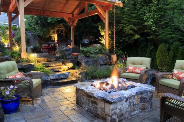Rustic Backyard Area With Stone Fire Pit | HGTV