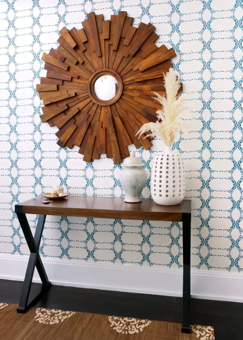 Foyer With Blue and White Patterned Wallpaper & Wood Starburst Mirror