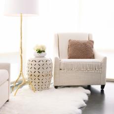 Neutral Upholstered Armchair With White Faux Fur Rug