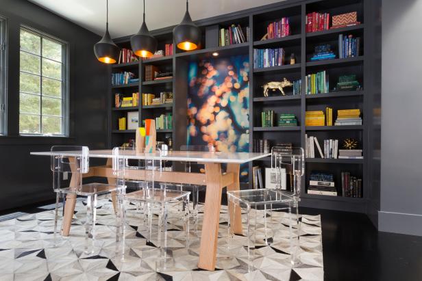 Black Modern Dining Space With Colorful Books & Acrylic Chairs 