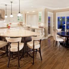 Contemporary Kitchen With Curved Eat-in Island and Connected Dining Space 