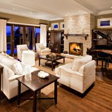 Elegant Traditional Living Room With Grand Piano, Stone Fireplace and White Furniture