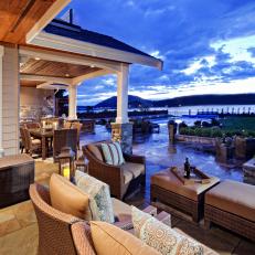 Dreamy Slate Patio With Gorgeous Water View and Brown Wicker Furniture