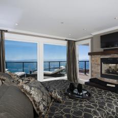 Masculine Bedroom With Ocean View Balcony & Stone Fireplace