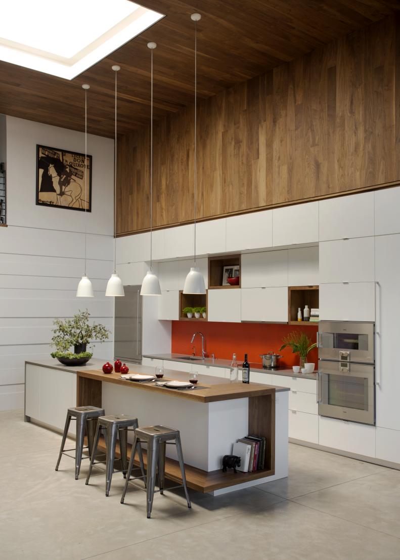 White Kitchen With Wood Paneling, Island and Orange Backsplash