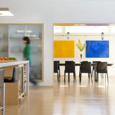Modern Kitchen and Dining Room With Colorful Paintings