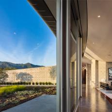 Modern Indoor-Outdoor Living Space Features Glass Perimeter & Arc Design