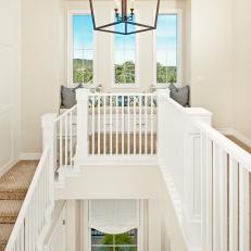 White Stairwell With Pendant Light and Window Seat