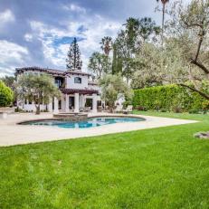 Spanish Colonial Home Features Landscaped Backyard With Swimming Pool