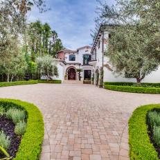 Neutral Stone Driveway Leads to Spanish Colonial Home 