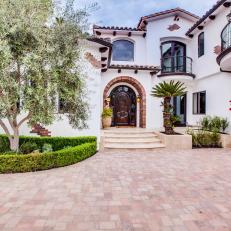 Entryway to Spanish Colonial Home With Large Olive Tree
