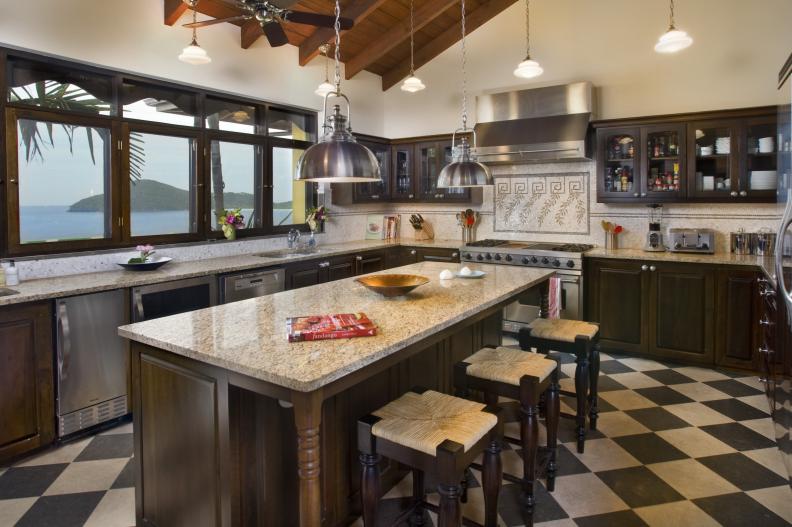 Kitchen With Neutral Granite Countertops and Dark Cabinetry