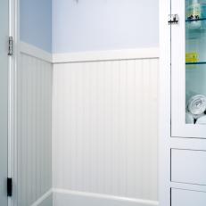 Blue Craftsman Bathroom With Penny Tile Floor and Hooks for Towels