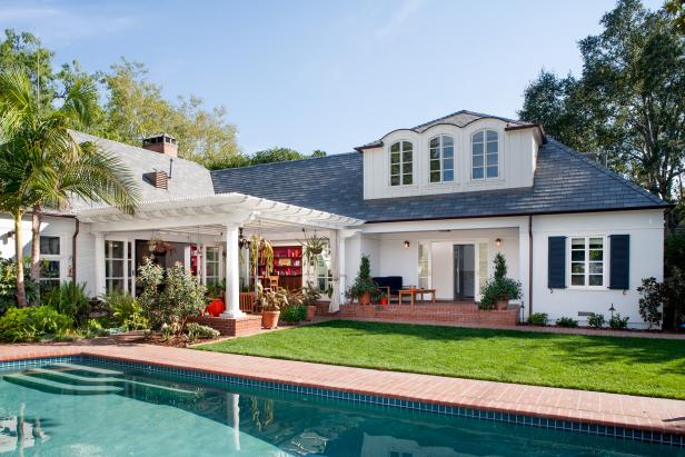 Exterior of White Two-Story Home With Pergola and Swimming Pool