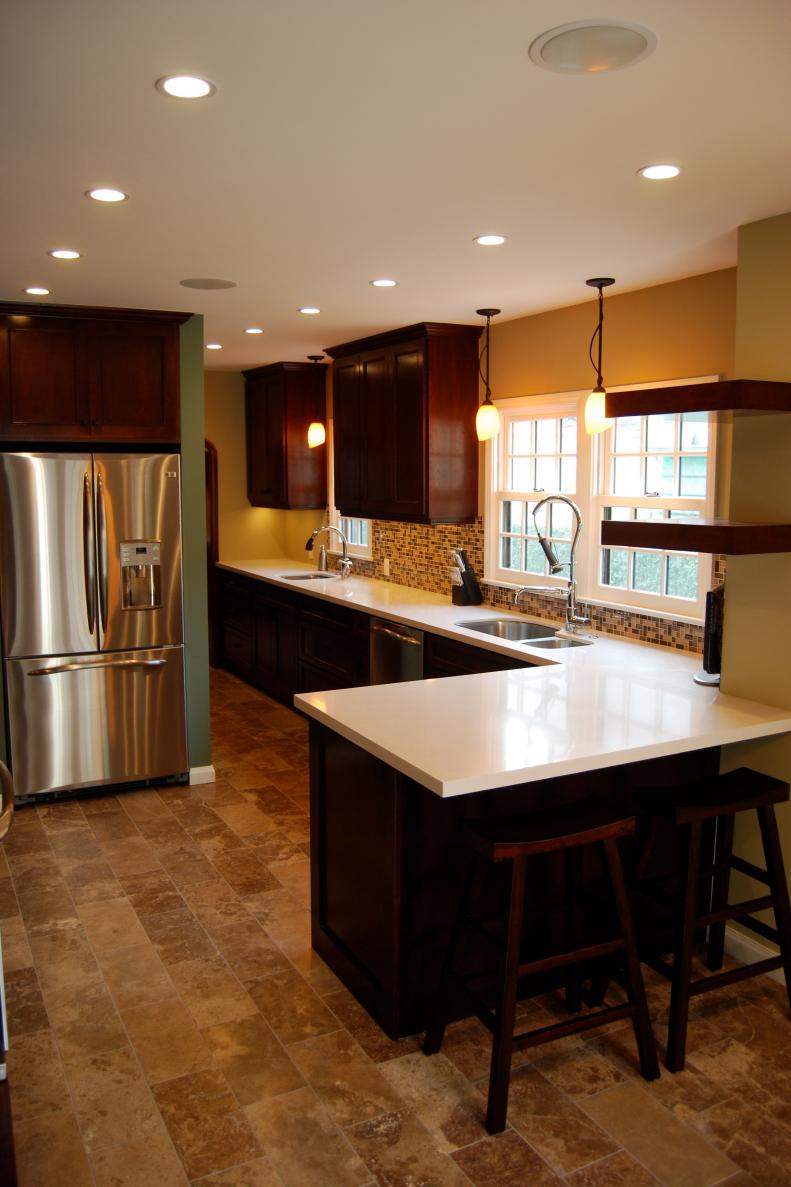 Yellow Open Kitchen With Stainless Fridge and Recessed Lighting