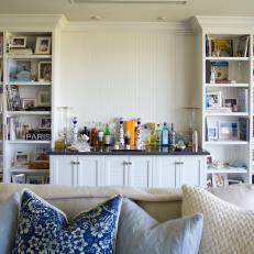 Transitional Living Room With Bar and Built-In Bookshelves