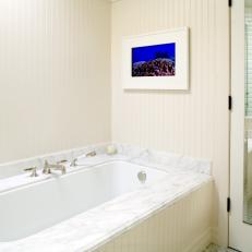 Ivory Paneled Bathroom With Marble Bathtub