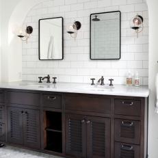 Arched Wall Around Dark Wood Double Vanity With White Countertop 