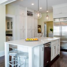 White Transitional Kitchen With Large Island, Globe Pendants and Stainless Steel Stools 