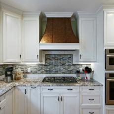 Traditional Kitchen With White Cabinetry & Copper Range Hood