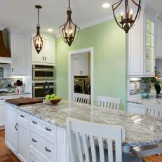Traditional Eat-In Kitchen With Island Seating & Iron Pendant Lights