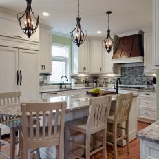 Traditional Kitchen With Eat-In Island and Wrought Iron Pendant Lighting 