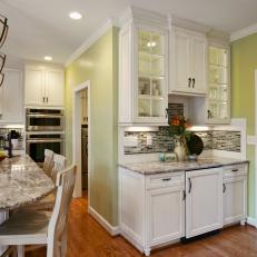 Traditional Kitchen With Marble Countertops and Wrought Iron Pendant Lighting 