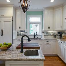 Traditional Kitchen With White Cabinetry and Gray and Blue Tile Backsplash 