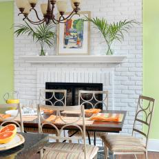 Tropical Green Dining Room Features Painted Brick Fireplace