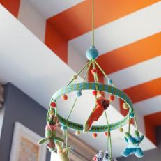 Orange and White Striped Ceiling and Woven Mobile