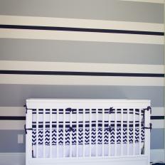 Blue and White Striped Nursery With White Crib