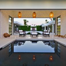 Elegant Covered Patio Flanked by Pool