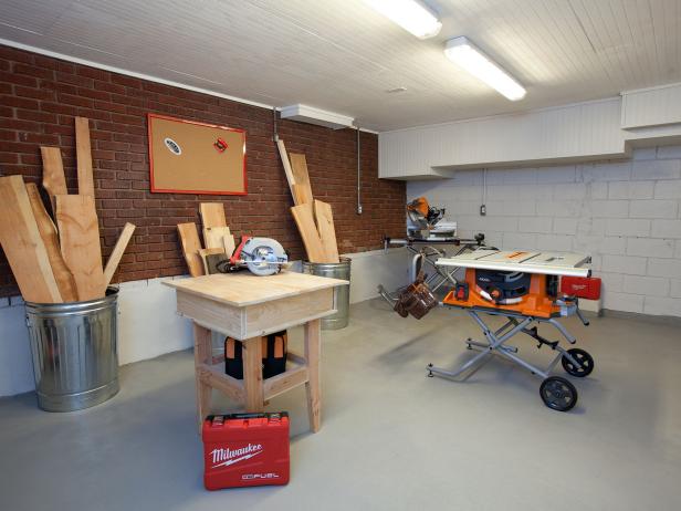 White Garage Workshop With Exposed Brick Wall and Beadboard Ceiling