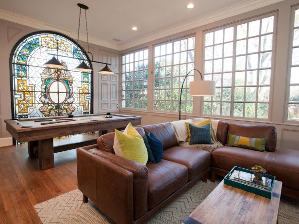 Living room with stained glass window and contemporary furnishings. 