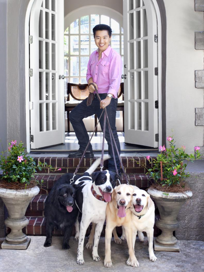 Vern Yip outside with his adopted dogs.