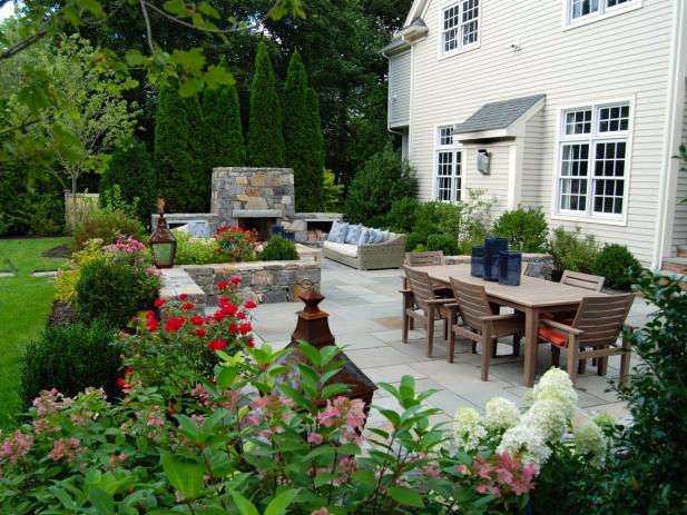 Backyard Bluestone Patio With Stacked Stone Retaining Walls | HGTV