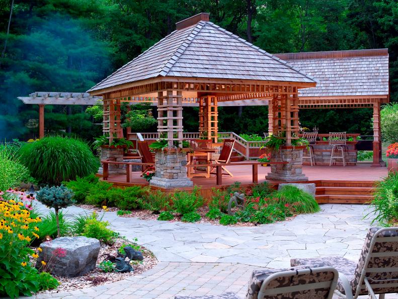 Stone Walkway With Wood Deck, Gazebo and Outdoor Dining Area