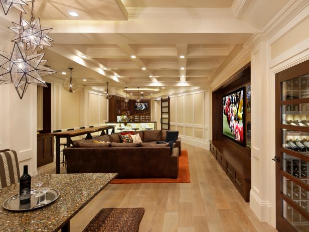 Neutral Room With Brown Sectional, Waffled Ceiling and Glass Pedants