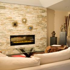 Neutral Sitting Area With Stacked Stone Fireplace