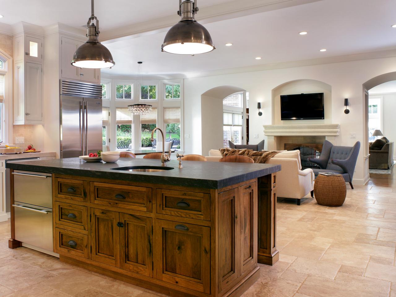 Rustic Kitchen Island With Dark Countertop And Refrigerator