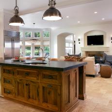 Rustic Kitchen Island With Dark Countertop and Refrigerator Drawers