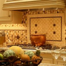 Mediterranean Kitchen with Custom Hood and Cooktop