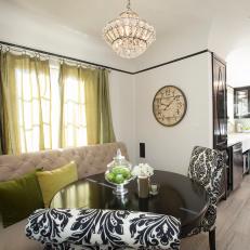 Dining Room With Banquette and Round Black Table