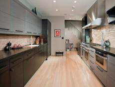 Modern Kitchen With Light Wood Floor and Black and Gray Cabinets